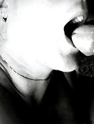 A sexy woman is touching her vagina with her fingers.