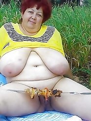 Shapely old granny is fingering her twat